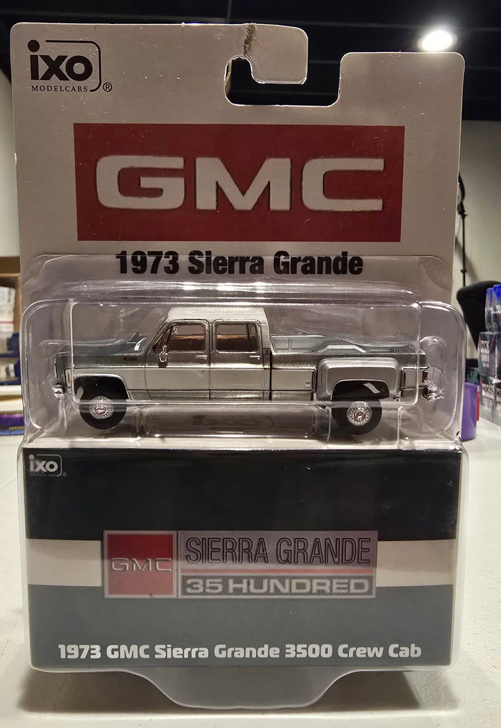 IXO America **Chase Raw (J-hook damage)** 1:64 Scale 1973 GMC Sierra Grande 3500 Crew Cab Dually - Glenwood Green and Frost White