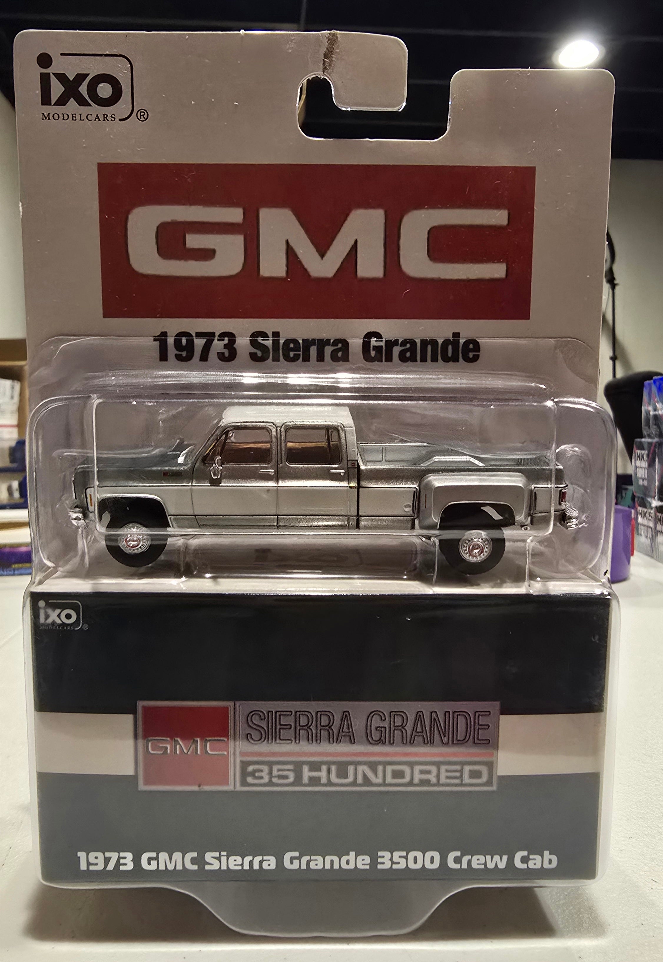IXO America **Chase Raw (J-hook damage)** 1:64 Scale 1973 GMC Sierra Grande 3500 Crew Cab Dually - Glenwood Green and Frost White